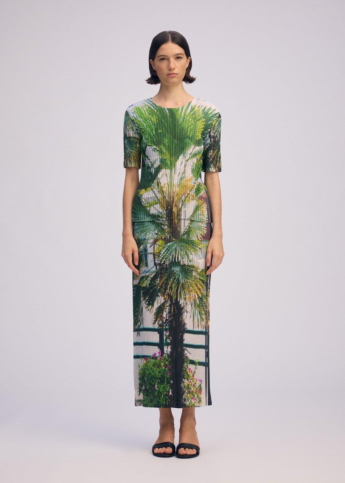 A model wears the Issey Miyake URBAN JUNGLE PLEATS shirt.