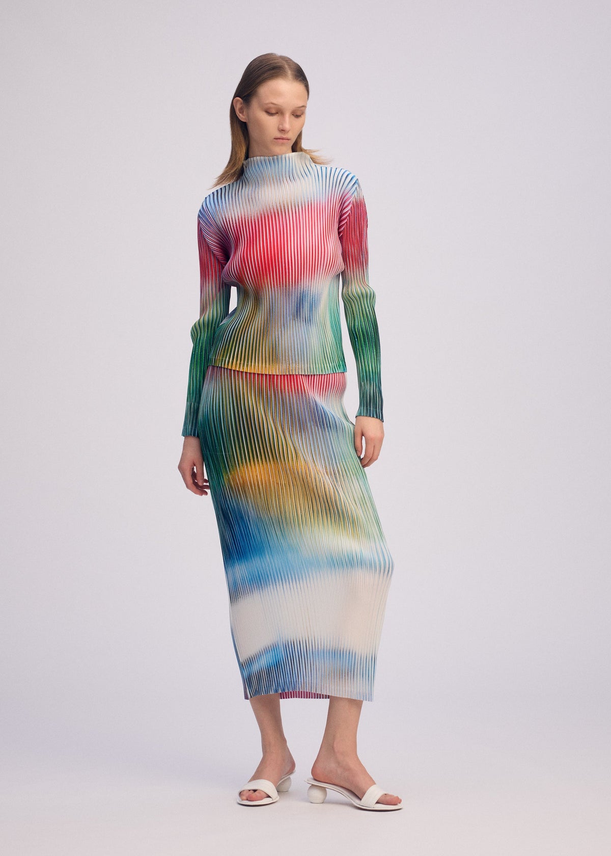 A model wears the ISSEY MIYAKE OBSCURE PLEATS prêt à porter.