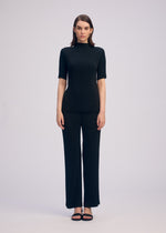 A model wears the ISSEY MIYAKE HATCHING PLEATS prêt à porter.