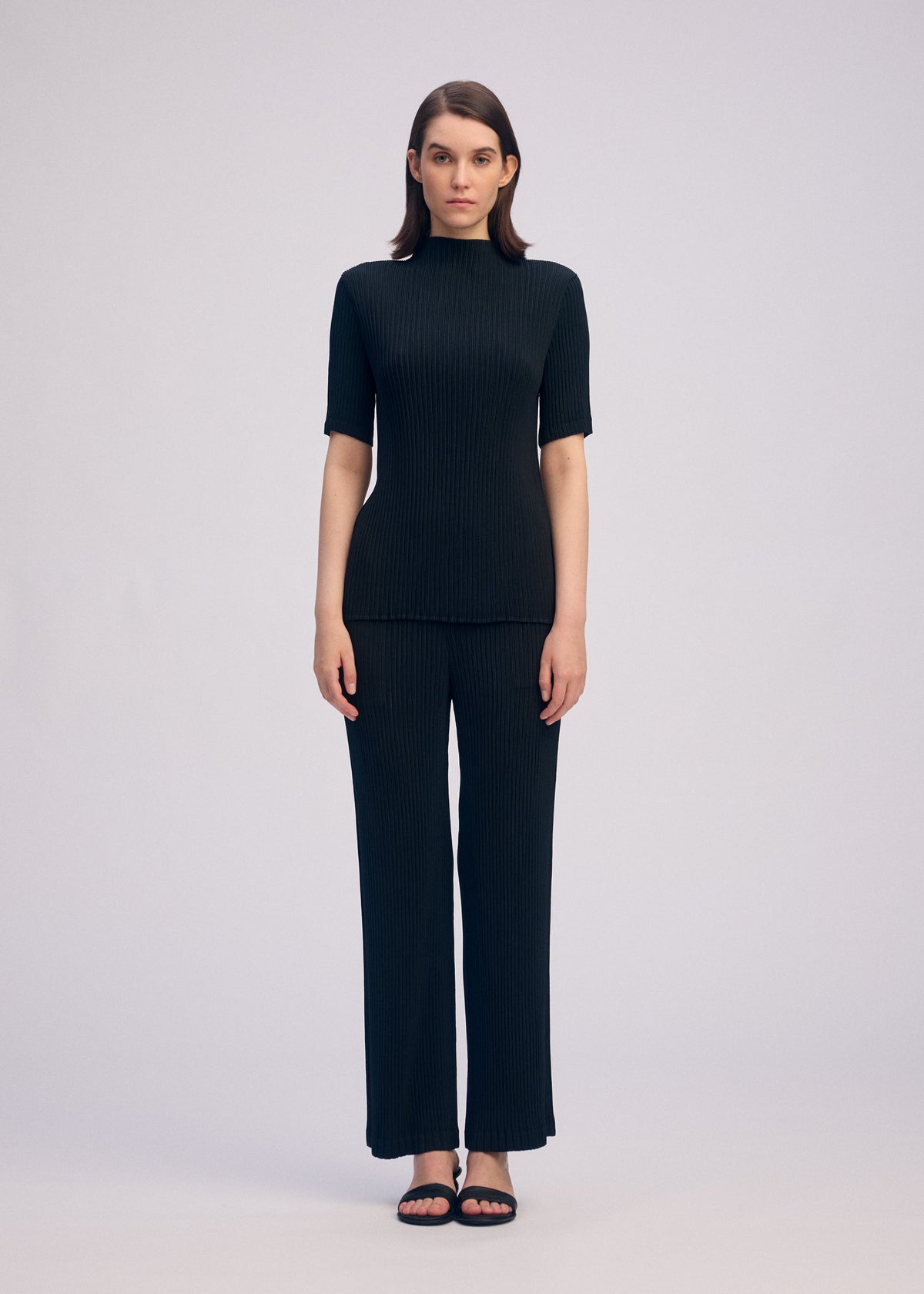 A model wears the ISSEY MIYAKE HATCHING PLEATS prêt à porter.