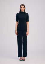 A model wears the ISSEY MIYAKE HATCHING PLEATS prêt à porter.