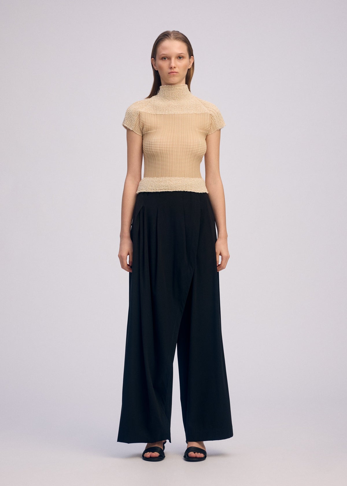A model wears the Issey Miyake SHEER FUZZY PLEATS shirt.
