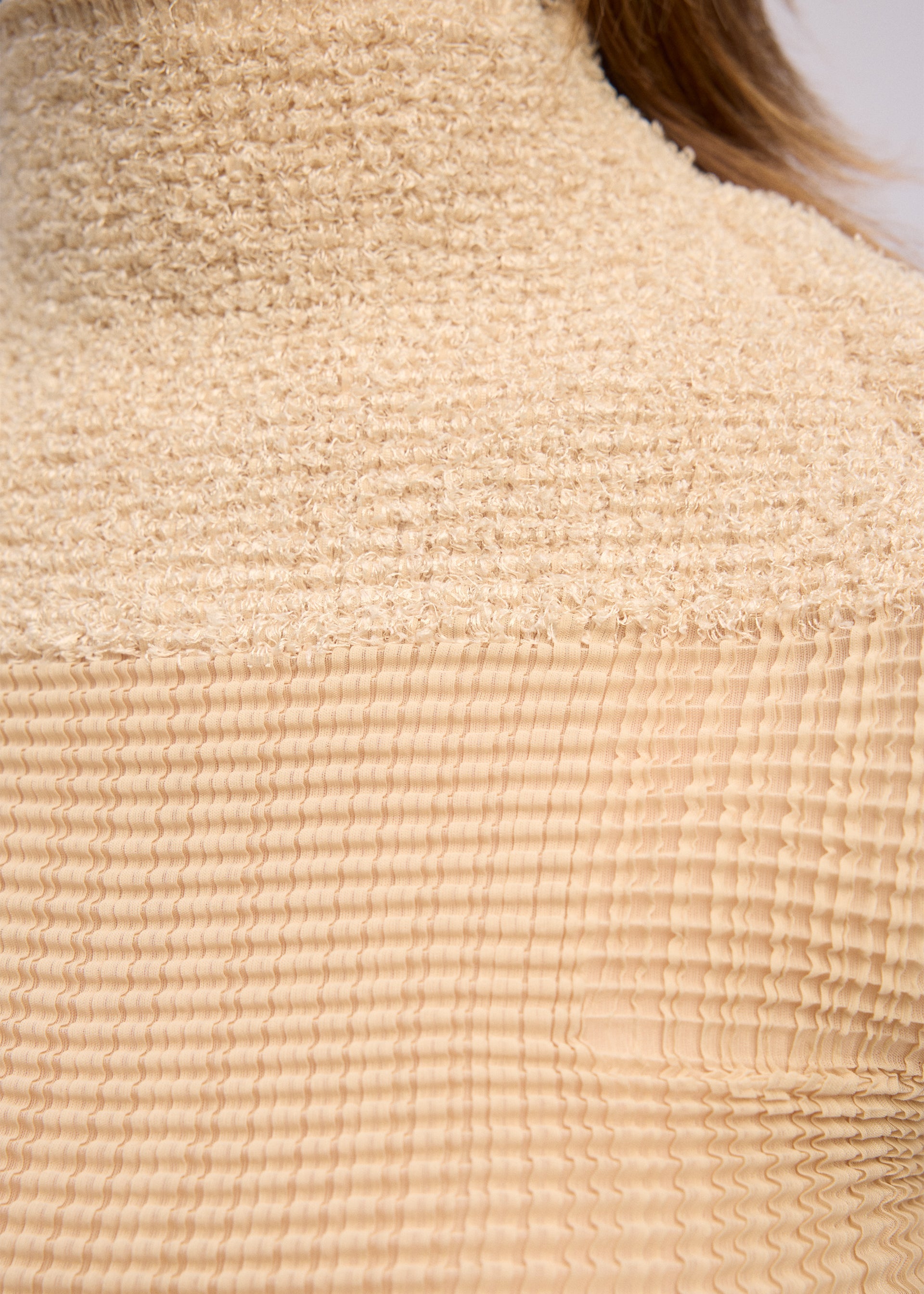 A model wears the Issey Miyake SHEER FUZZY PLEATS shirt.