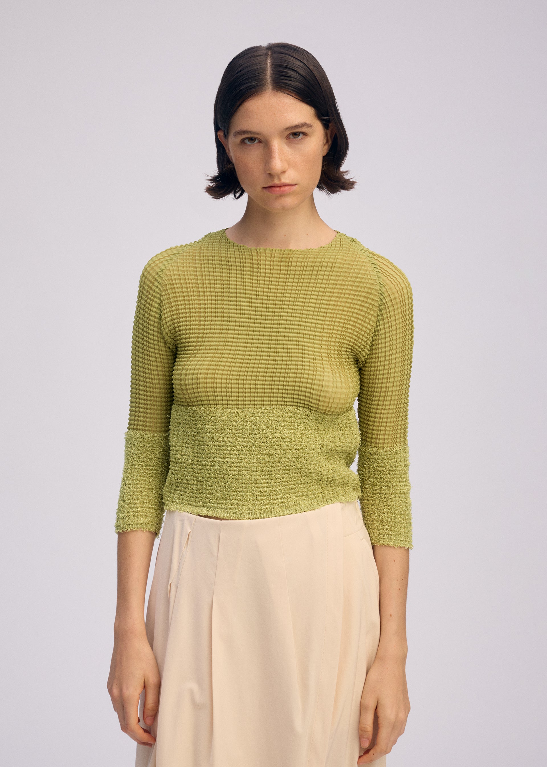 A model wears the Issey Miyake SHEER FUZZY PLEATS shirt.
