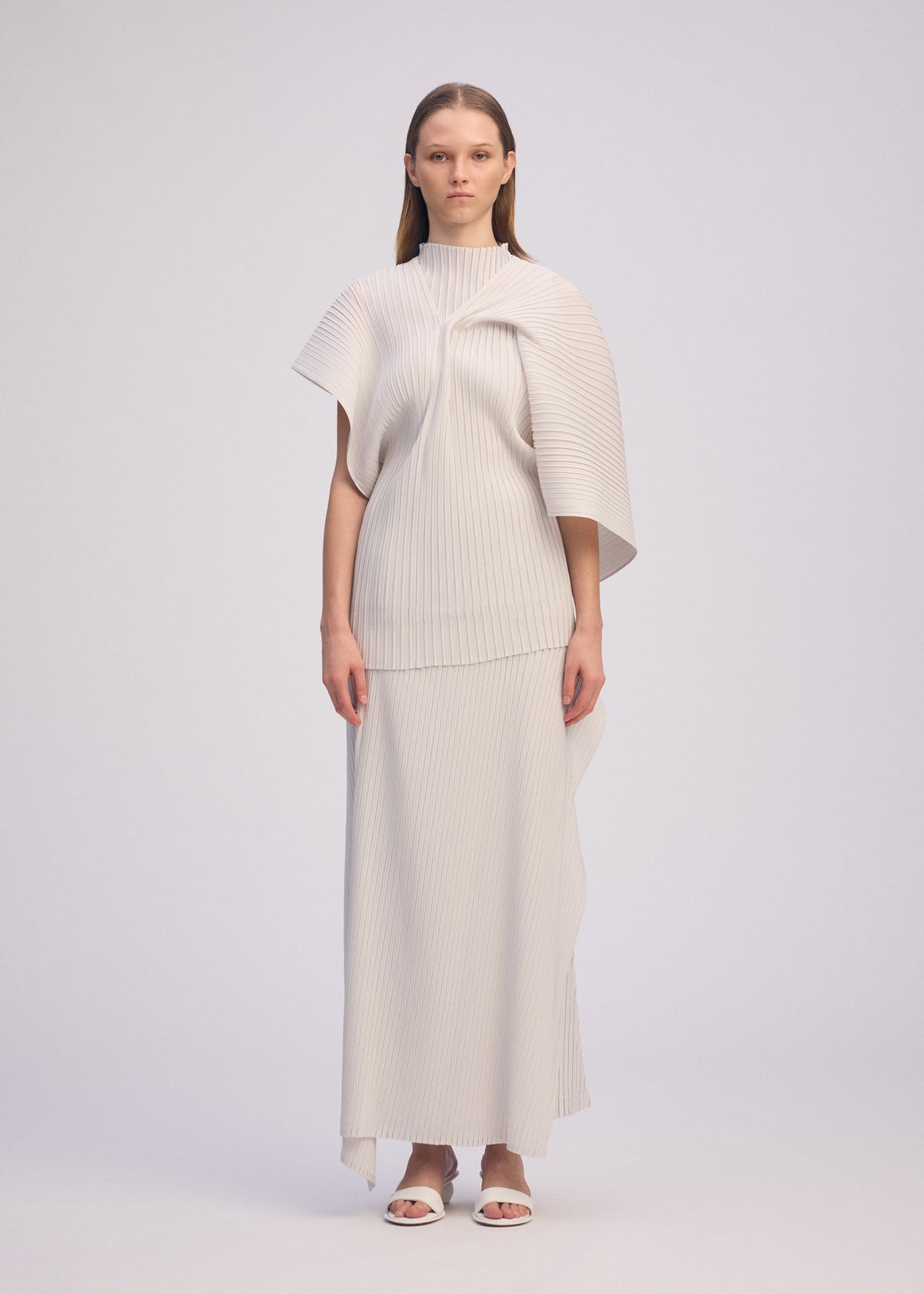 A model wears the ISSEY MIYAKE PLEATED ON PLEATS shirt.