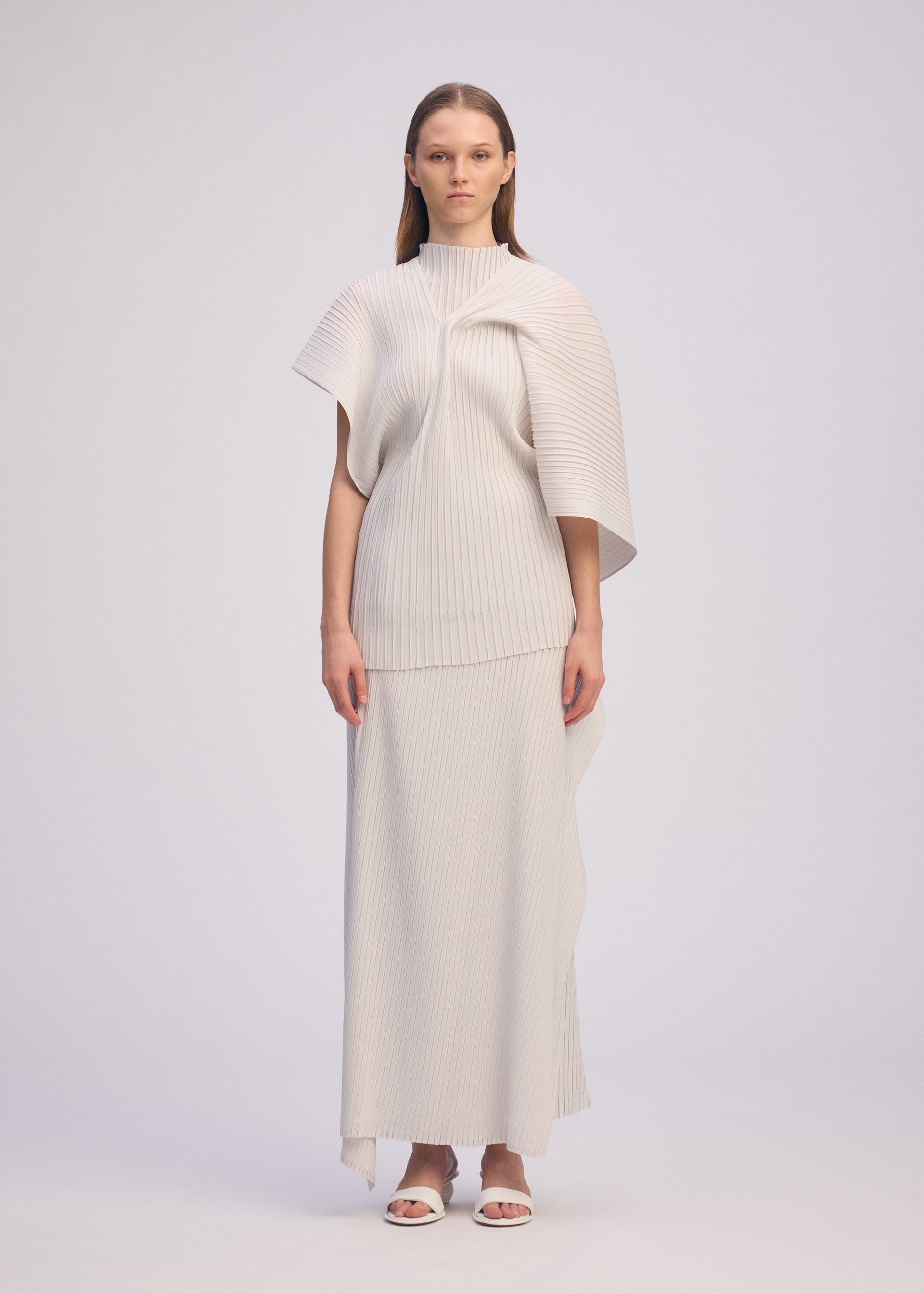 A model wears the ISSEY MIYAKE PLEATED ON PLEATS shirt.
