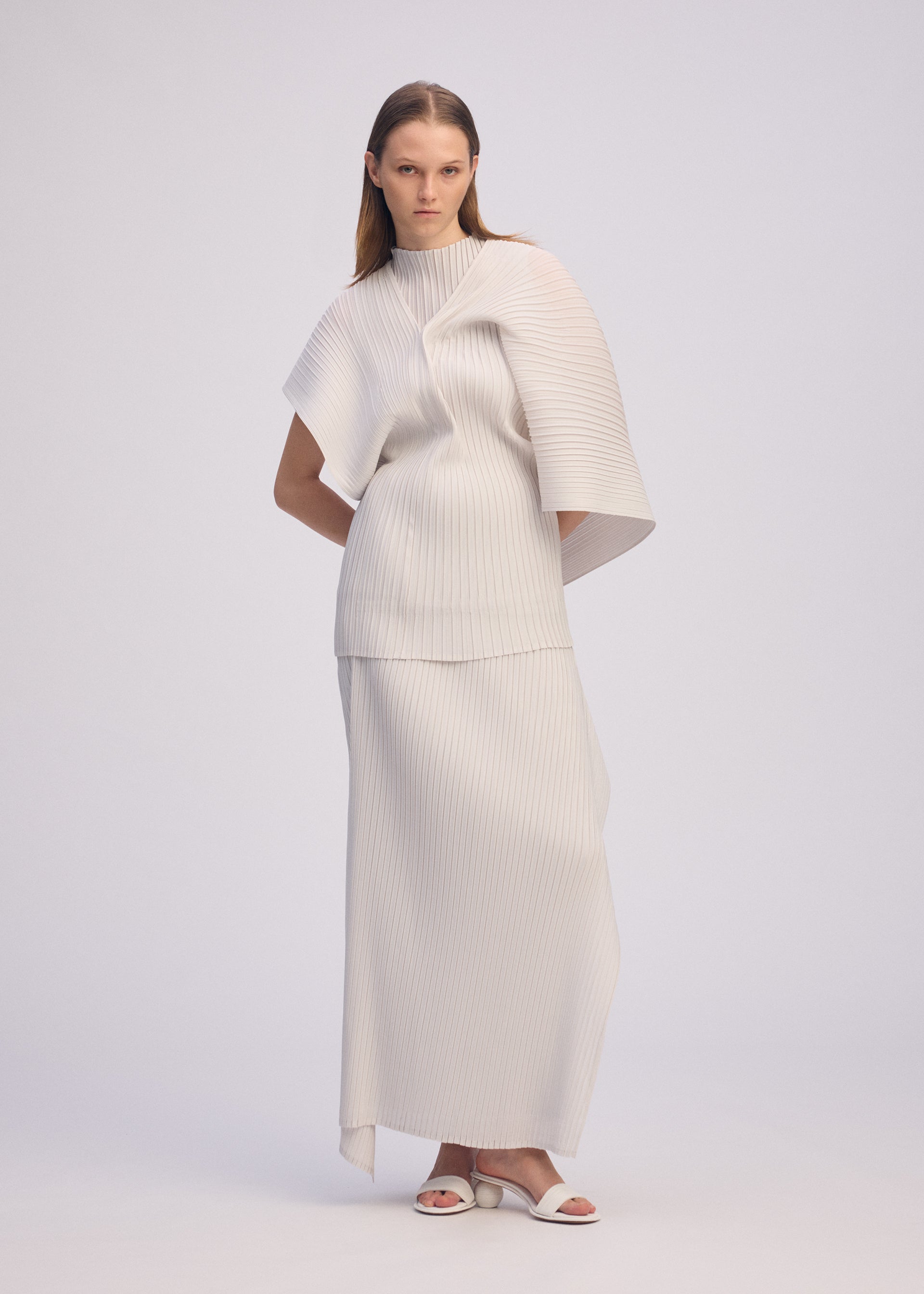 A model wears the ISSEY MIYAKE PLEATED ON PLEATS shirt.