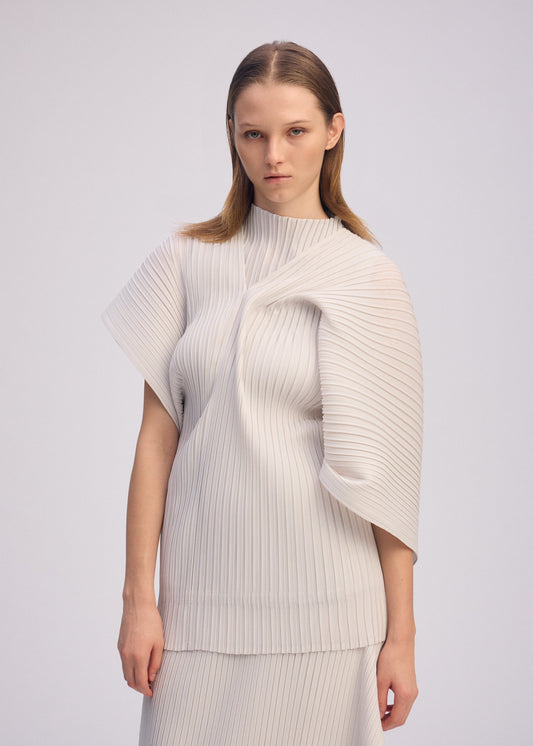 A model wears the ISSEY MIYAKE PLEATED ON PLEATS shirt.
