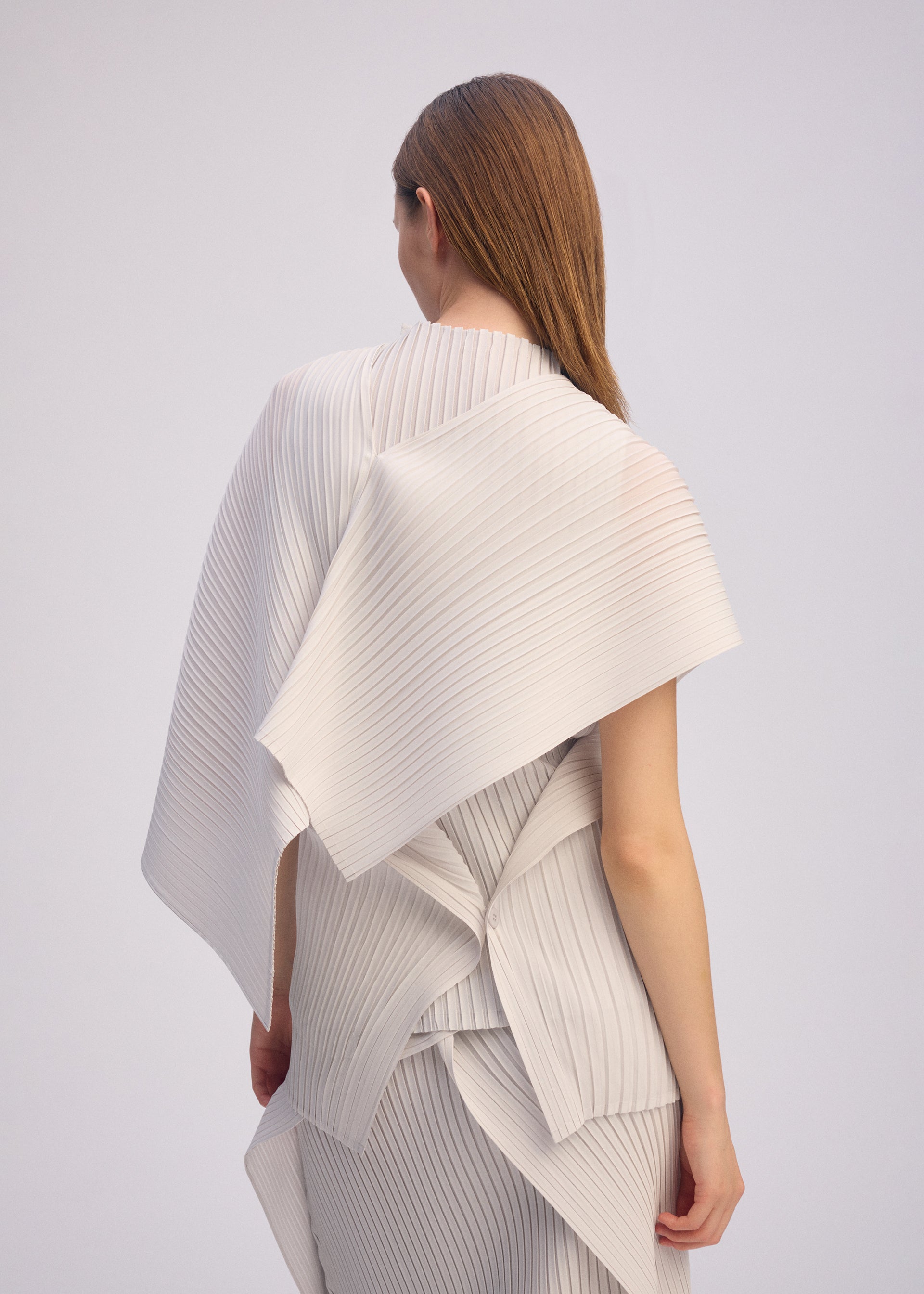 A model wears the ISSEY MIYAKE PLEATED ON PLEATS shirt.