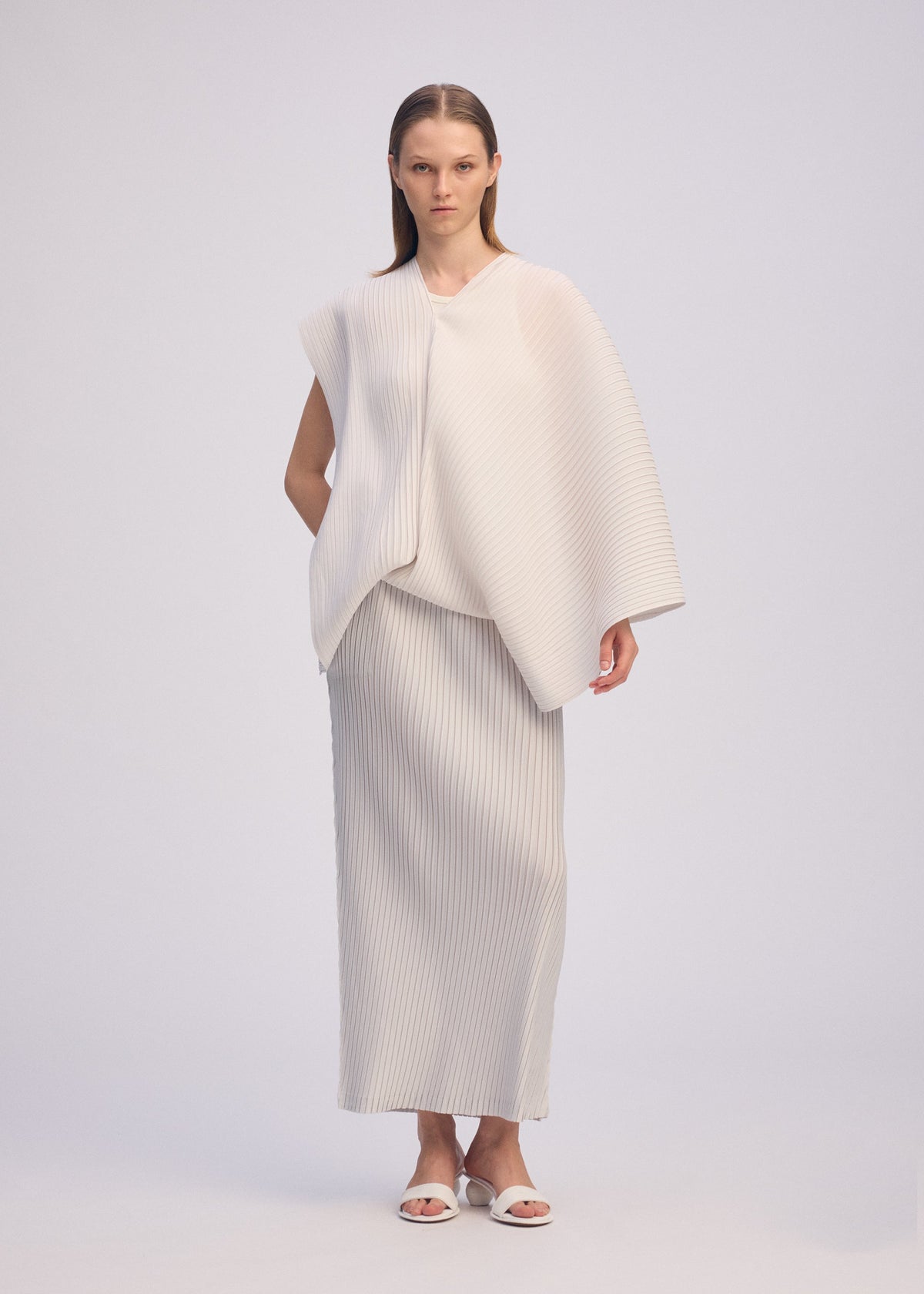 A model wears the ISSEY MIYAKE PLEATED ON PLEATS shirt.