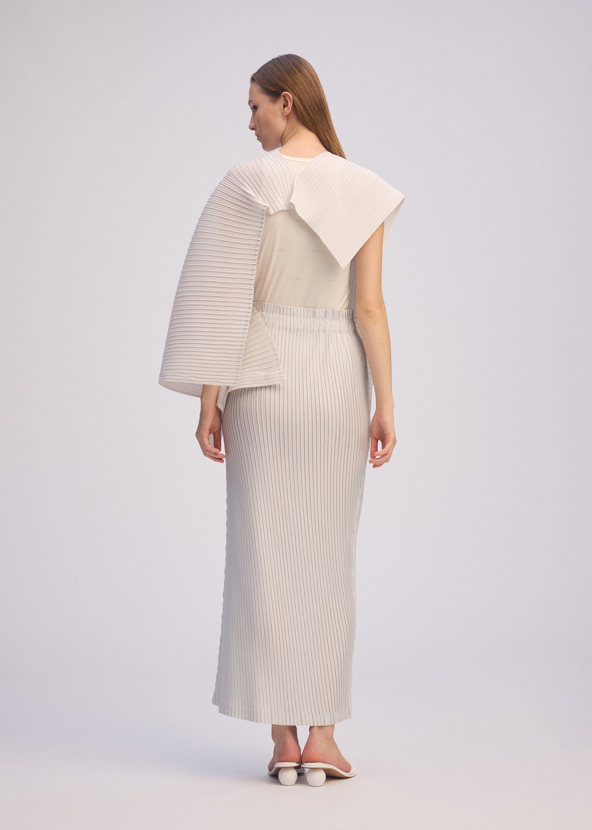 A model wears the ISSEY MIYAKE PLEATED ON PLEATS shirt.
