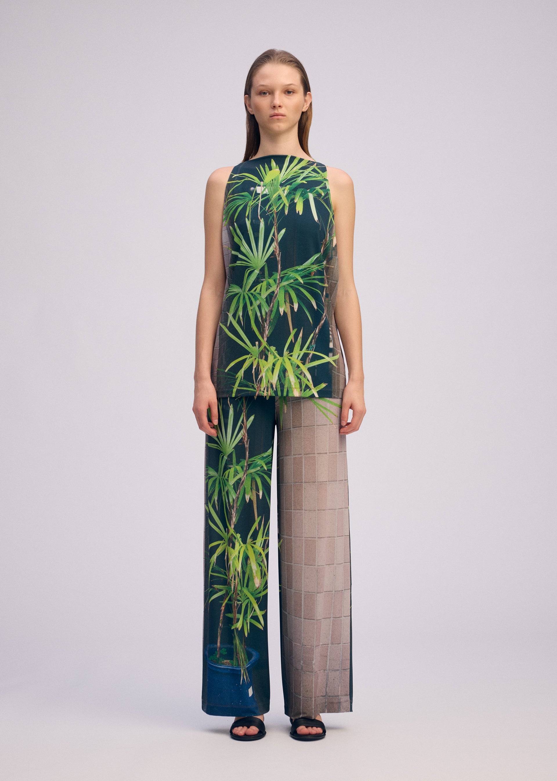 A model wears the Issey Miyake URBAN JUNGLE JERSEY pants.