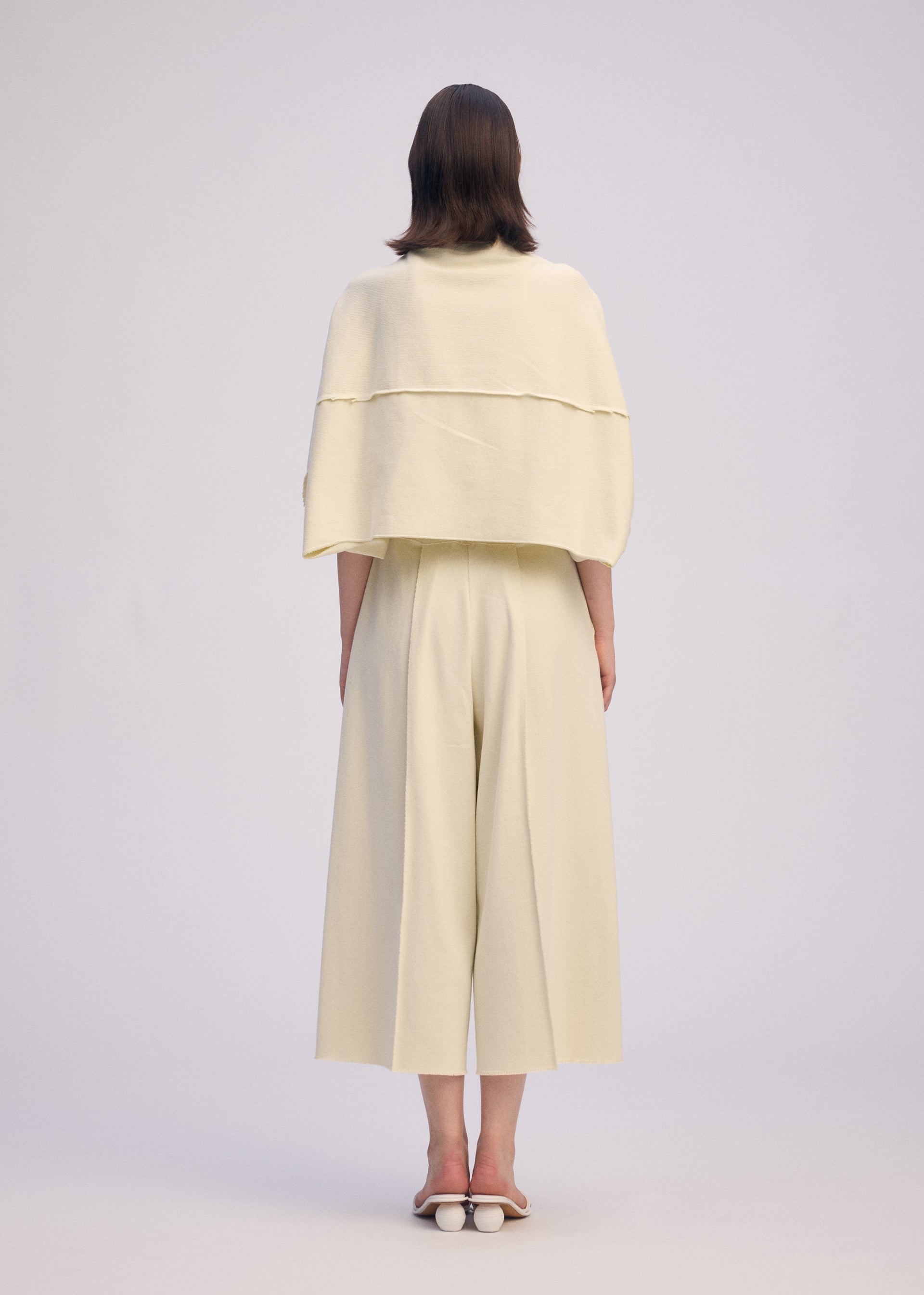 A model wears the ISSEY MIYAKE CAMPAGNE prêt à porter.