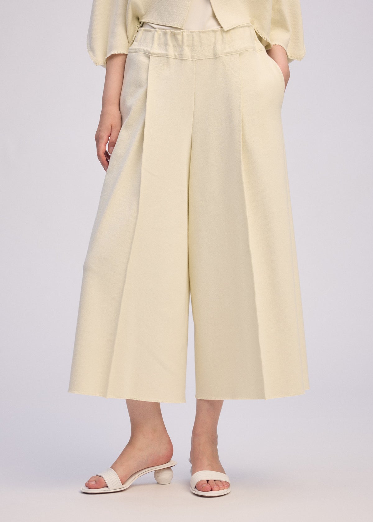 A model wears the ISSEY MIYAKE CAMPAGNE prêt à porter.