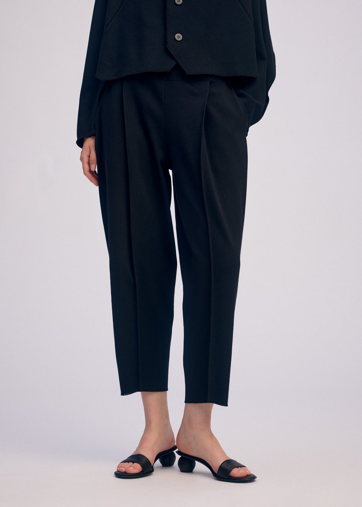 A model wears the ISSEY MIYAKE CAMPAGNE prêt à porter.