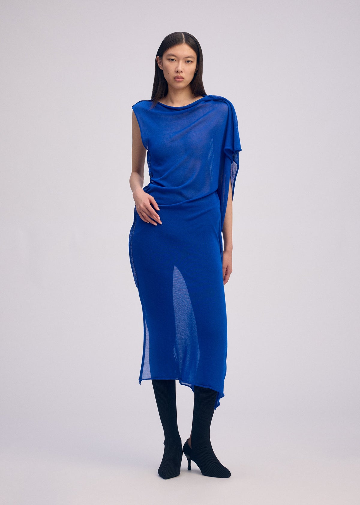 A model wears the ISSEY MIYAKE CONCEALED KNIT concealed-knit-dress-black.