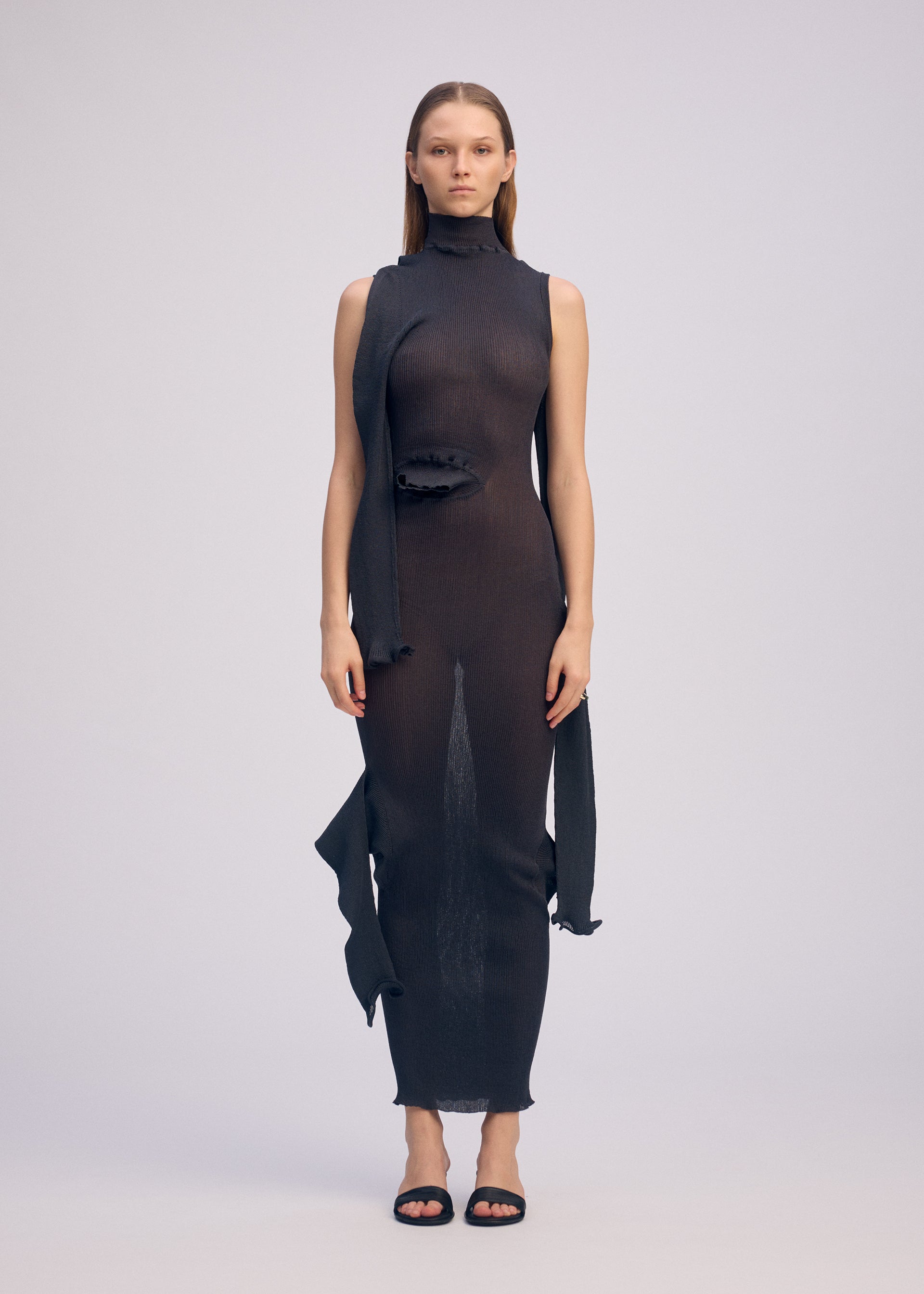A model wears the ISSEY MIYAKE ADVENTITIOUS?SLEEVES dress.