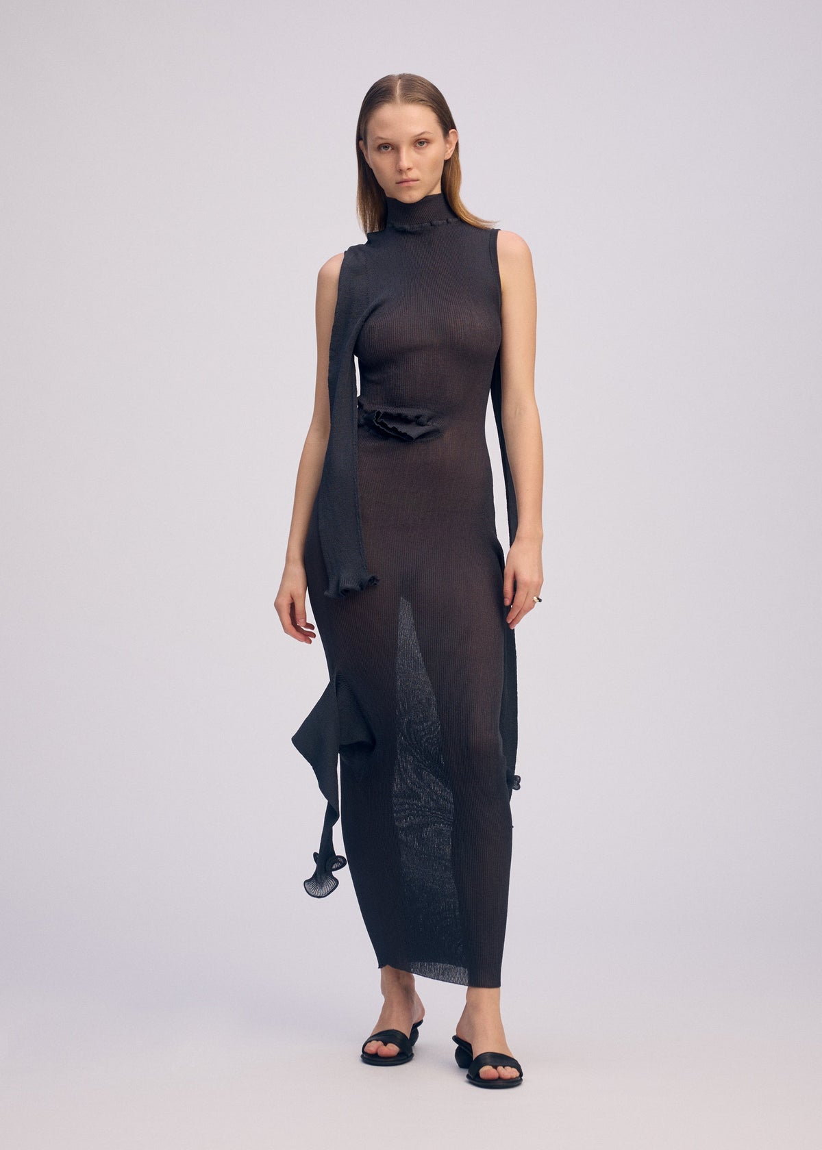 A model wears the ISSEY MIYAKE ADVENTITIOUS?SLEEVES dress.