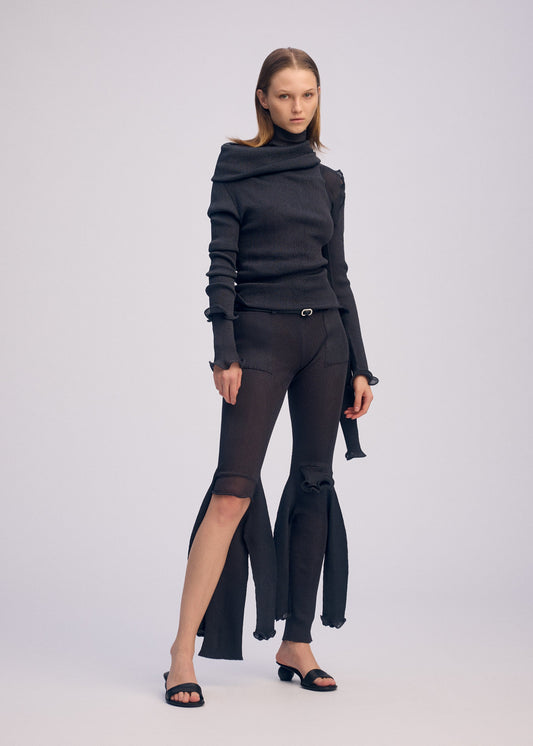 A model wears the ISSEY MIYAKE ADVENTITIOUS?SLEEVES dress.