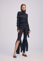 A model wears the ISSEY MIYAKE ADVENTITIOUS?SLEEVES dress.