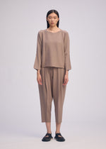 A model wears the ISSEY MIYAKE CAMPAGNE prêt à porter.