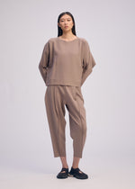 A model wears the ISSEY MIYAKE CAMPAGNE prêt à porter.