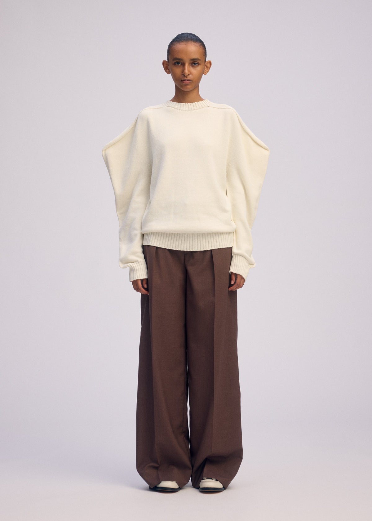 A model wears the ISSEY MIYAKE AKIMBO KNIT prêt à porter.