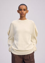 A model wears the ISSEY MIYAKE AKIMBO KNIT prêt à porter.