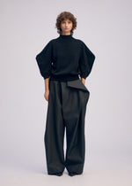 A model wears the ISSEY MIYAKE AKIMBO KNIT prêt à porter.