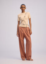 A model wears the ISSEY MIYAKE BELT LOOP KNIT top.