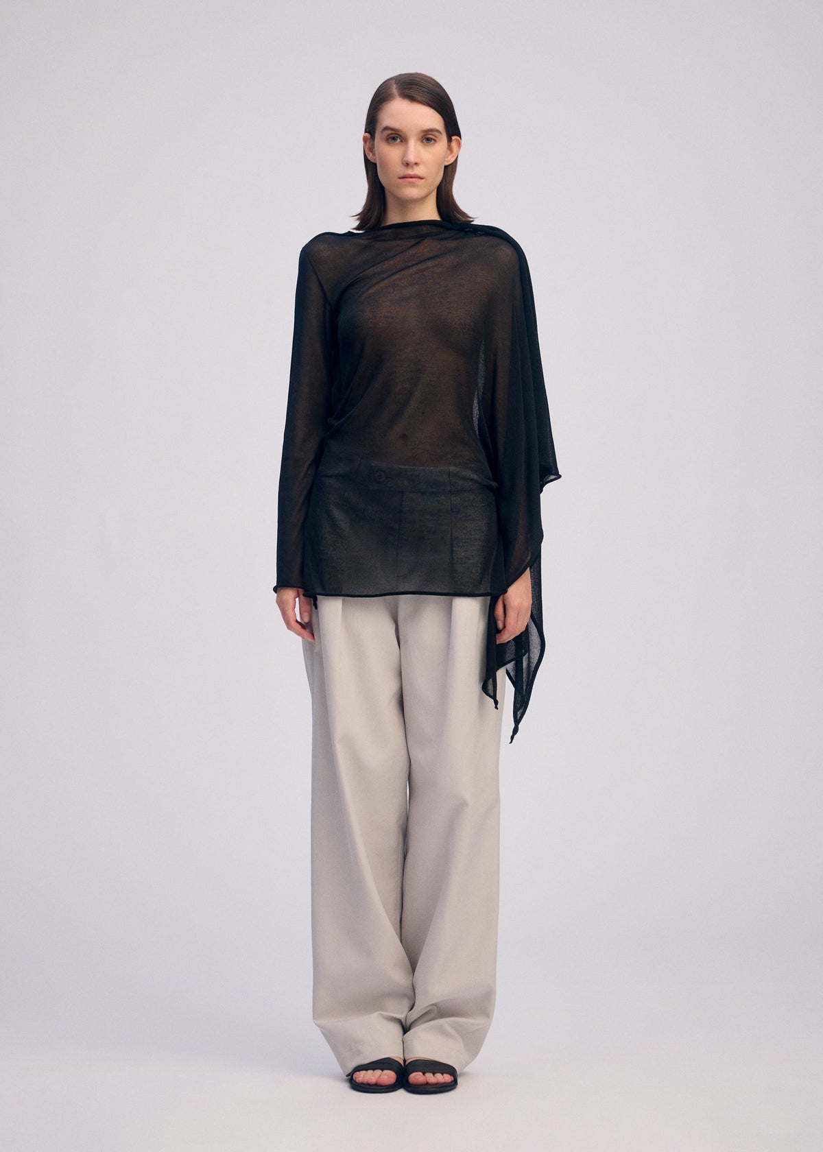 A model wears the ISSEY MIYAKE CONCEALED KNIT concealed-knit-top-starling-blue.