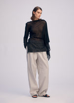 A model wears the ISSEY MIYAKE CONCEALED KNIT concealed-knit-top-light-grey.