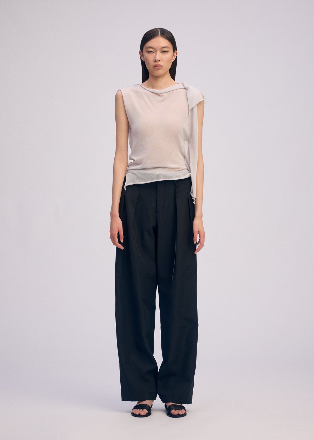 A model wears the ISSEY MIYAKE CONCEALED KNIT concealed-knit-top-light-grey-1.