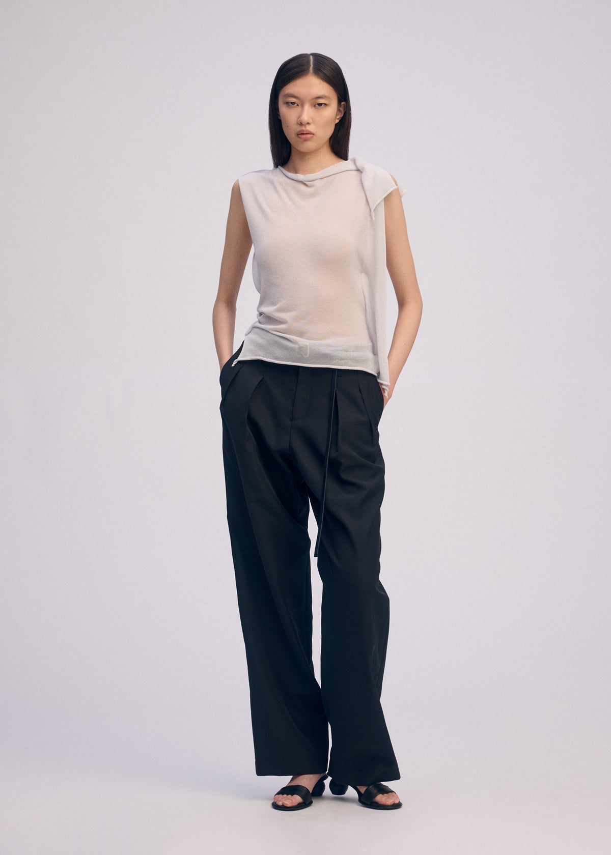 A model wears the ISSEY MIYAKE CONCEALED KNIT concealed-knit-top-black-1.