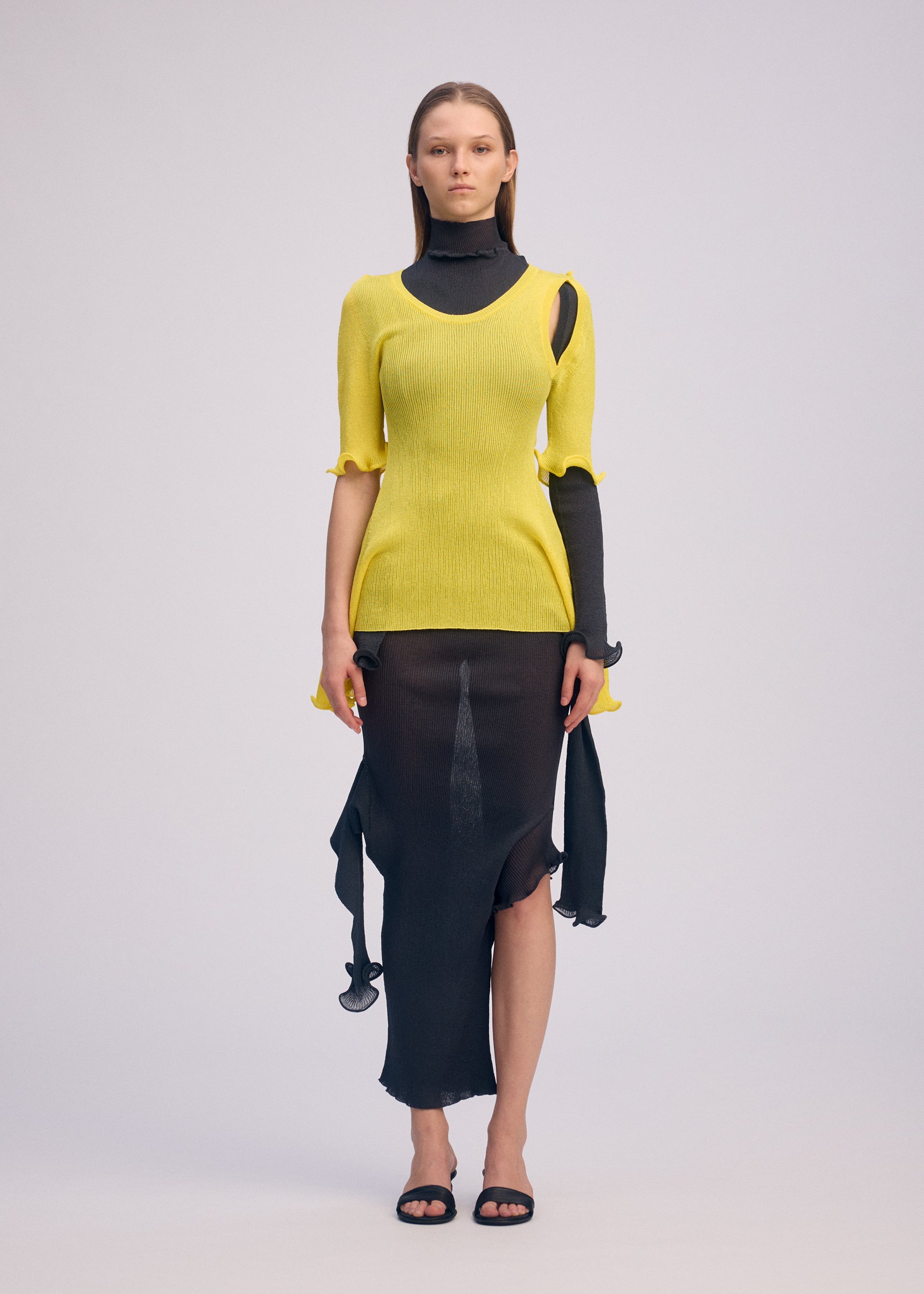 A model wears the ISSEY MIYAKE ADVENTITIOUS?SLEEVES top.