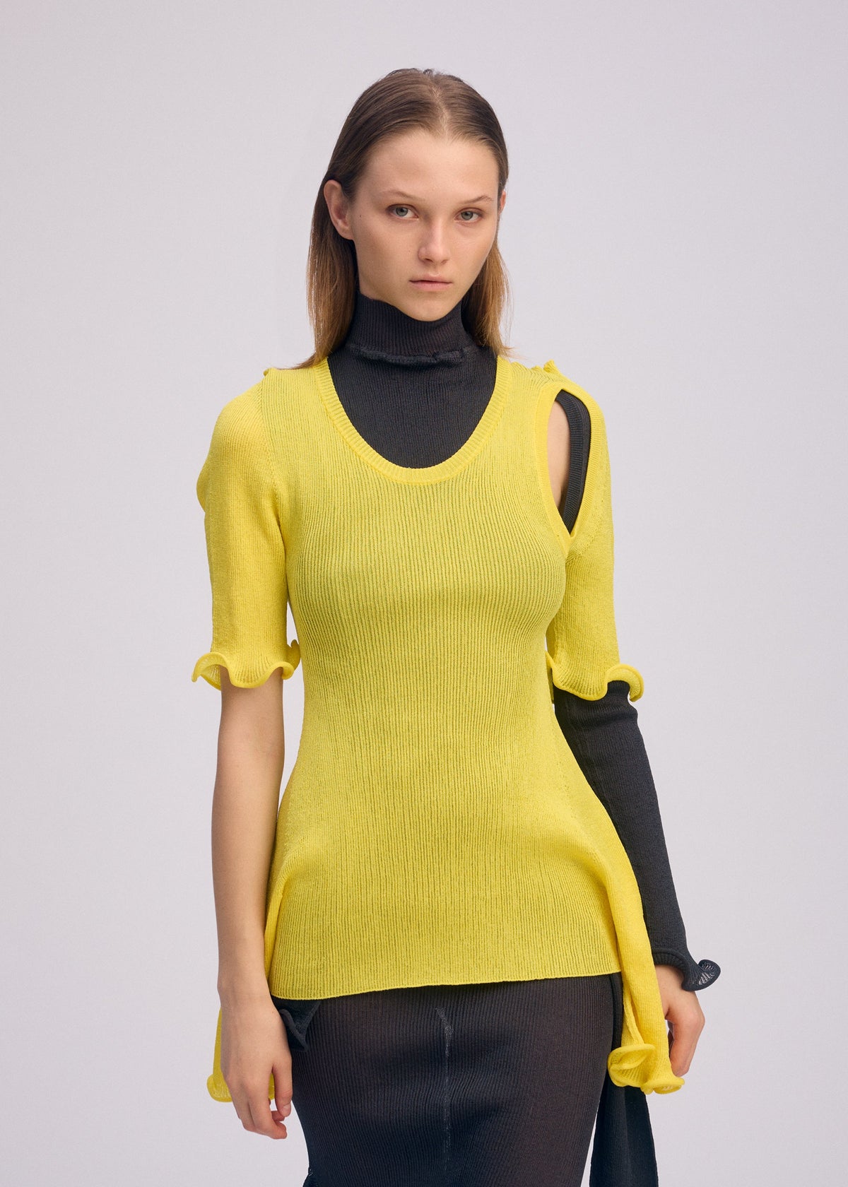 A model wears the ISSEY MIYAKE ADVENTITIOUS?SLEEVES top.