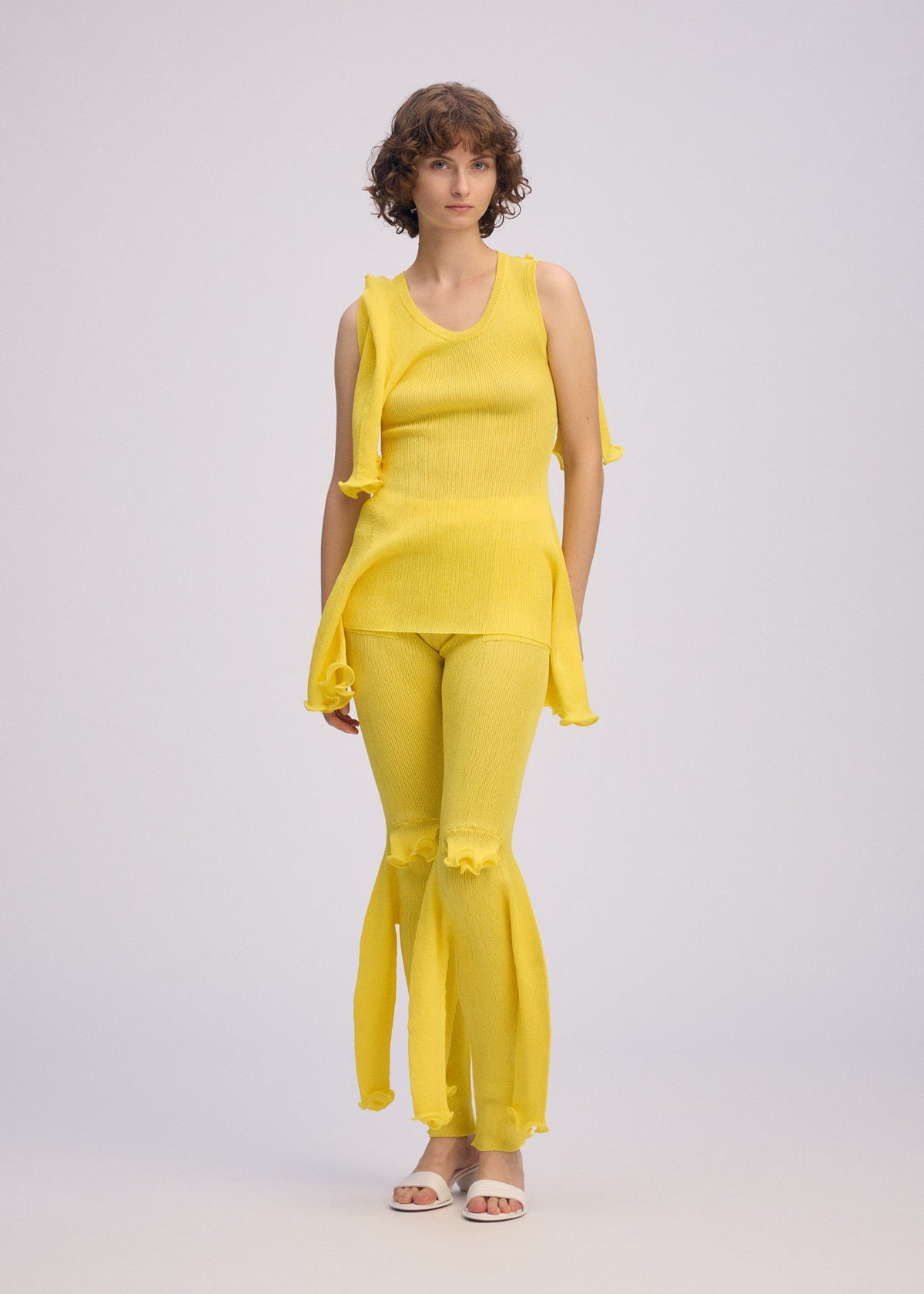 A model wears the ISSEY MIYAKE ADVENTITIOUS?SLEEVES top.