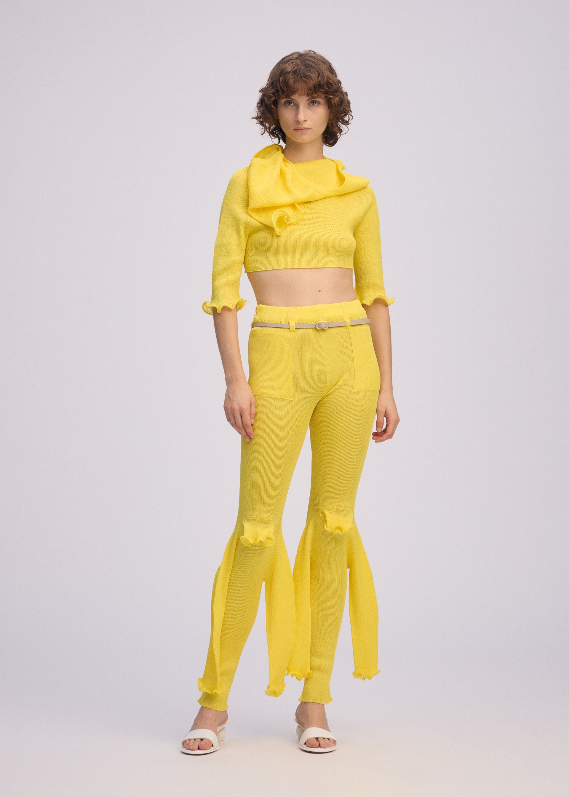 A model wears the ISSEY MIYAKE ADVENTITIOUS?SLEEVES top.