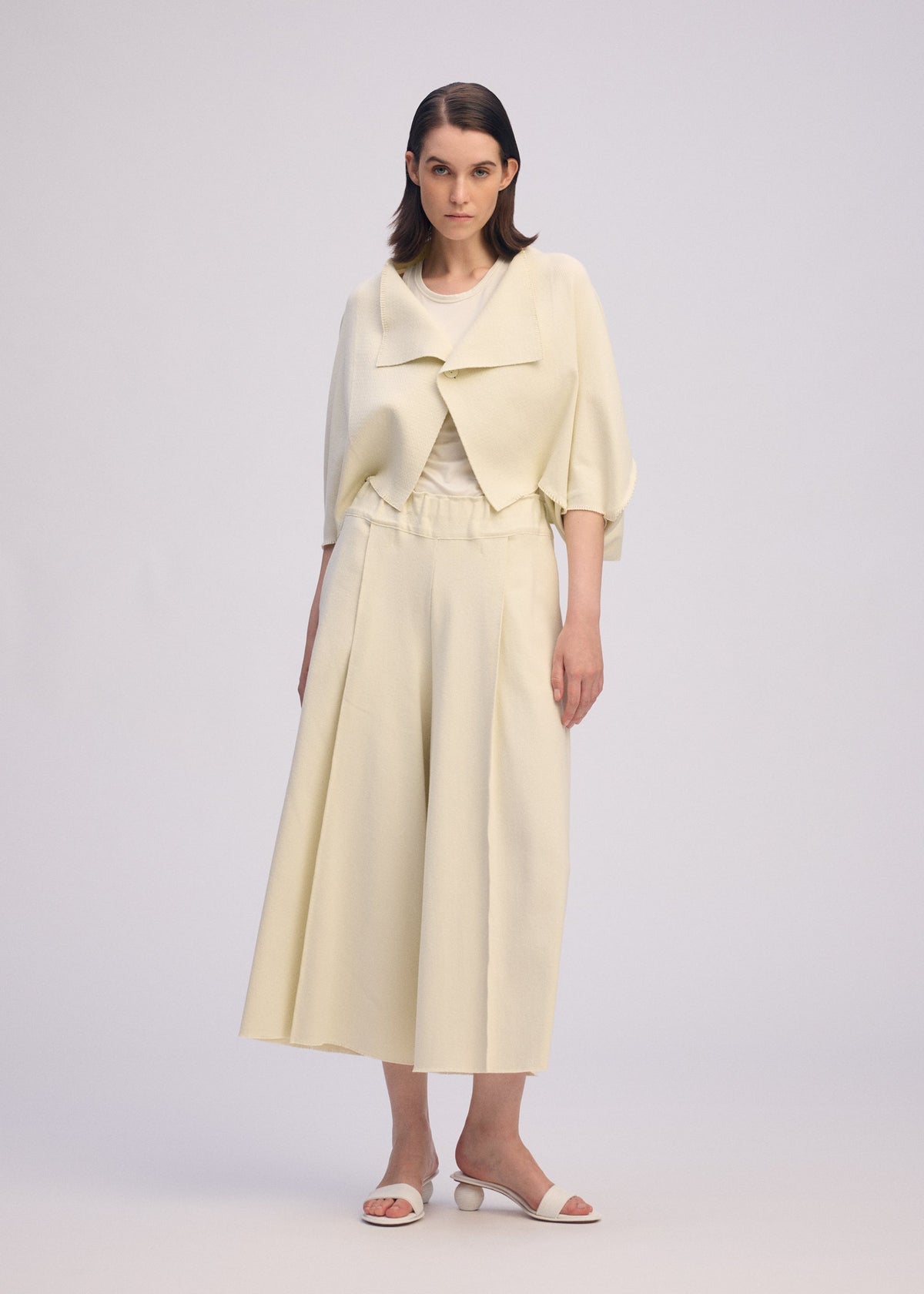 A model wears the ISSEY MIYAKE CAMPAGNE prêt à porter.