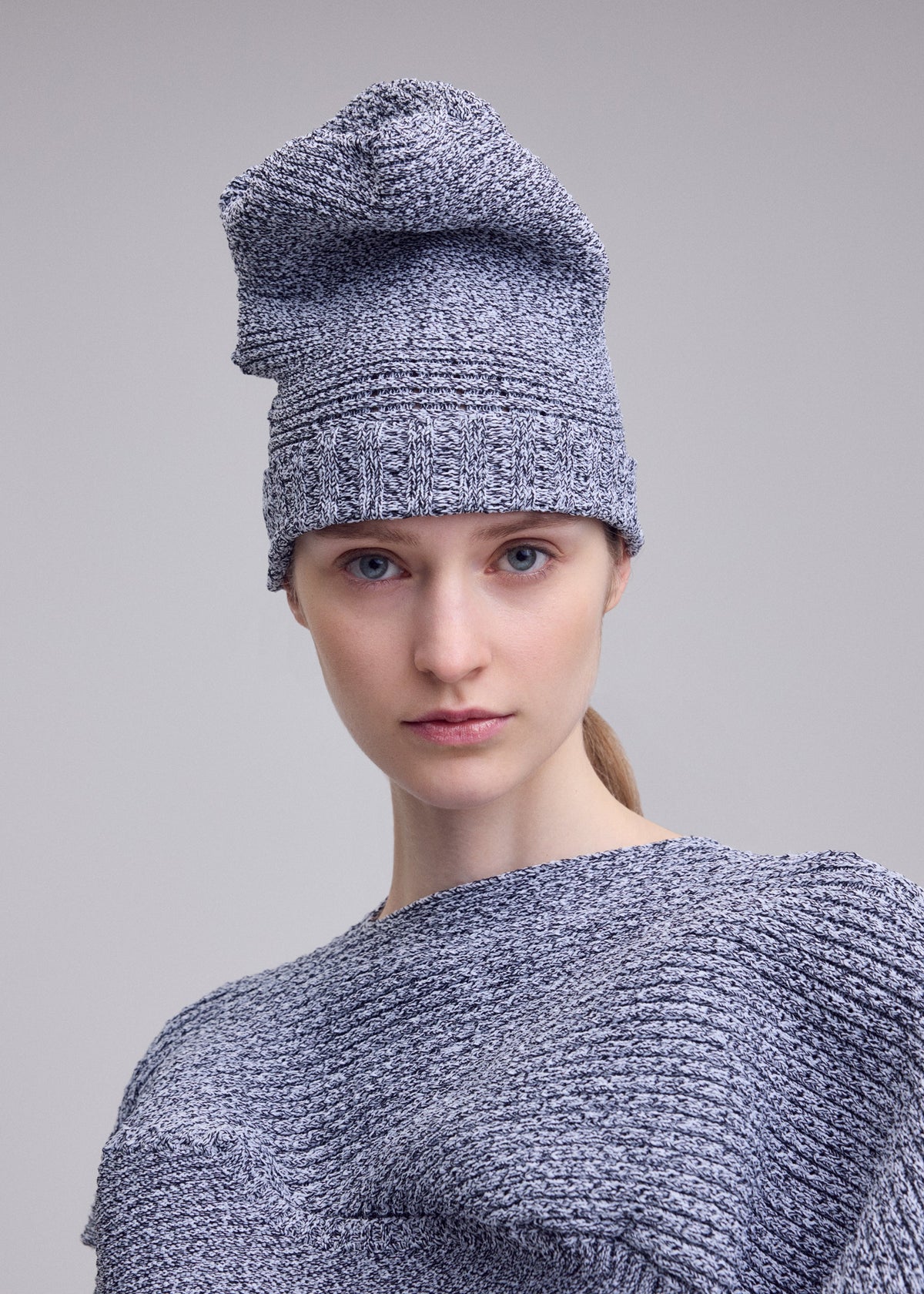 A model wears the ISSEY MIYAKE FOUND STONE BEANIE found-stone-beanie-cap-black-2.