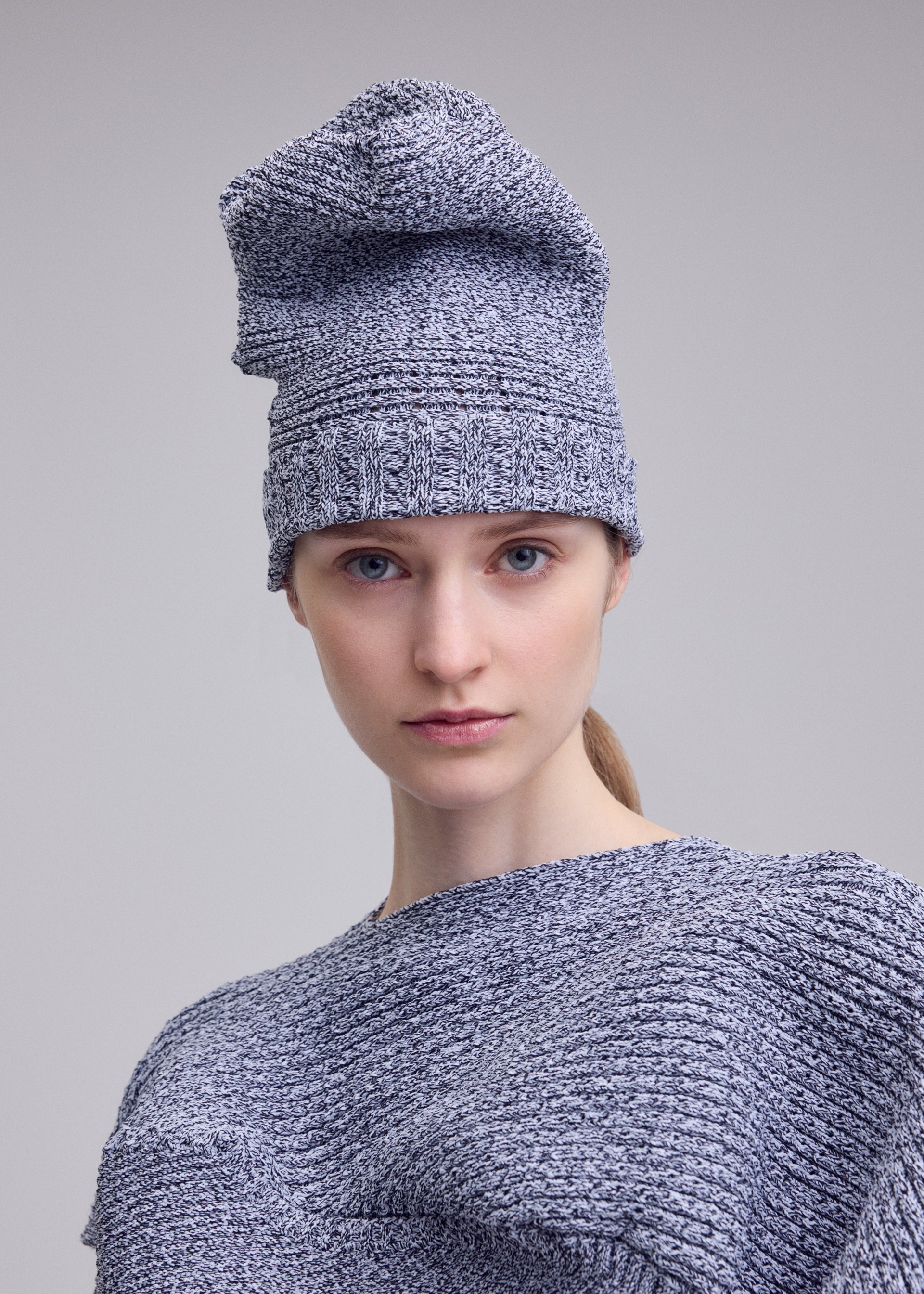 A model wears the ISSEY MIYAKE FOUND STONE BEANIE found-stone-beanie-cap-black-2.