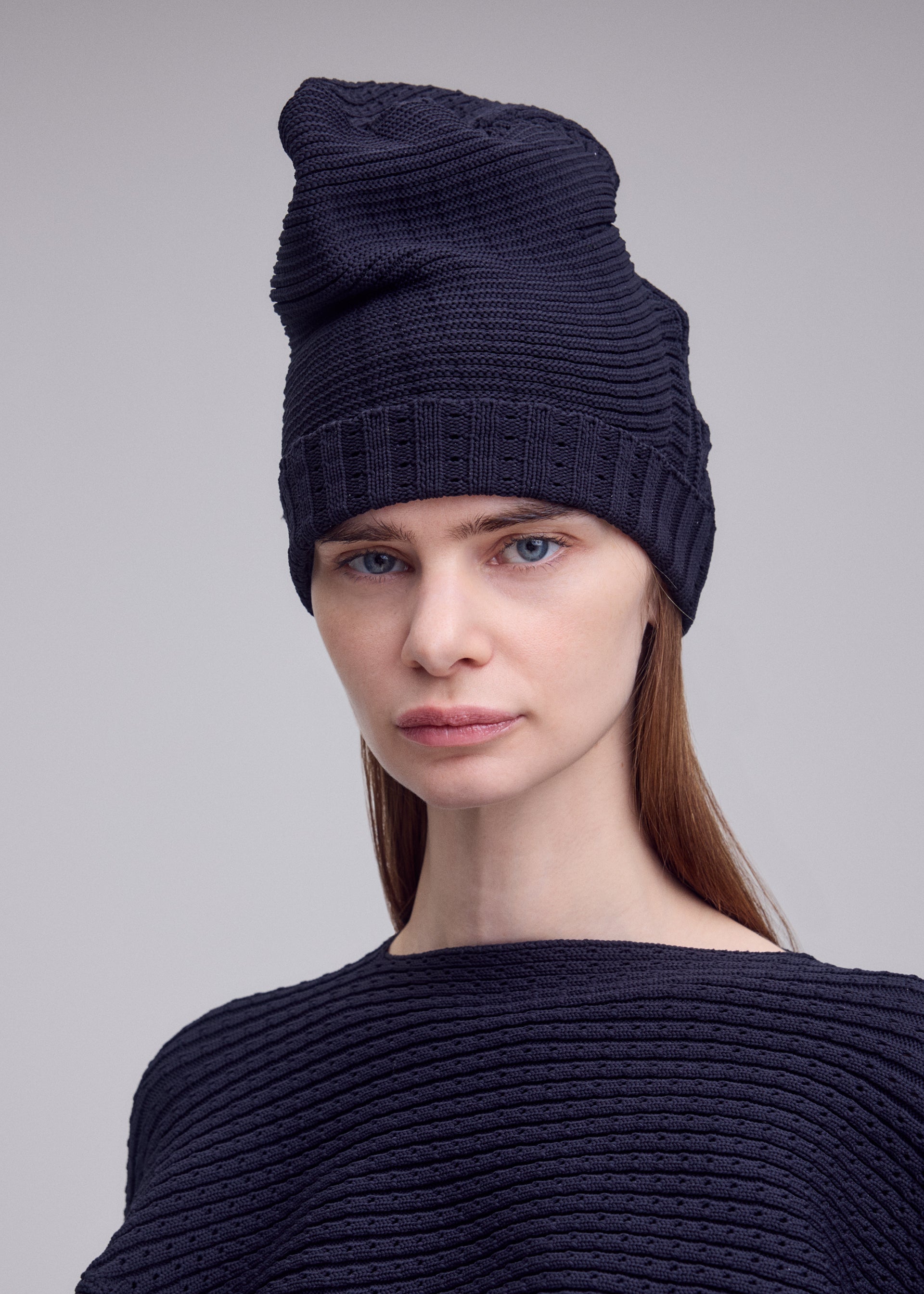 A model wears the ISSEY MIYAKE FOUND STONE BEANIE found-stone-beanie-cap-grey-1.