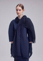 A model wears the ISSEY MIYAKE GRADATION RAMIE PLEATS STOLE gradation-ramie-pleats-stole-stole-black-hued-1.