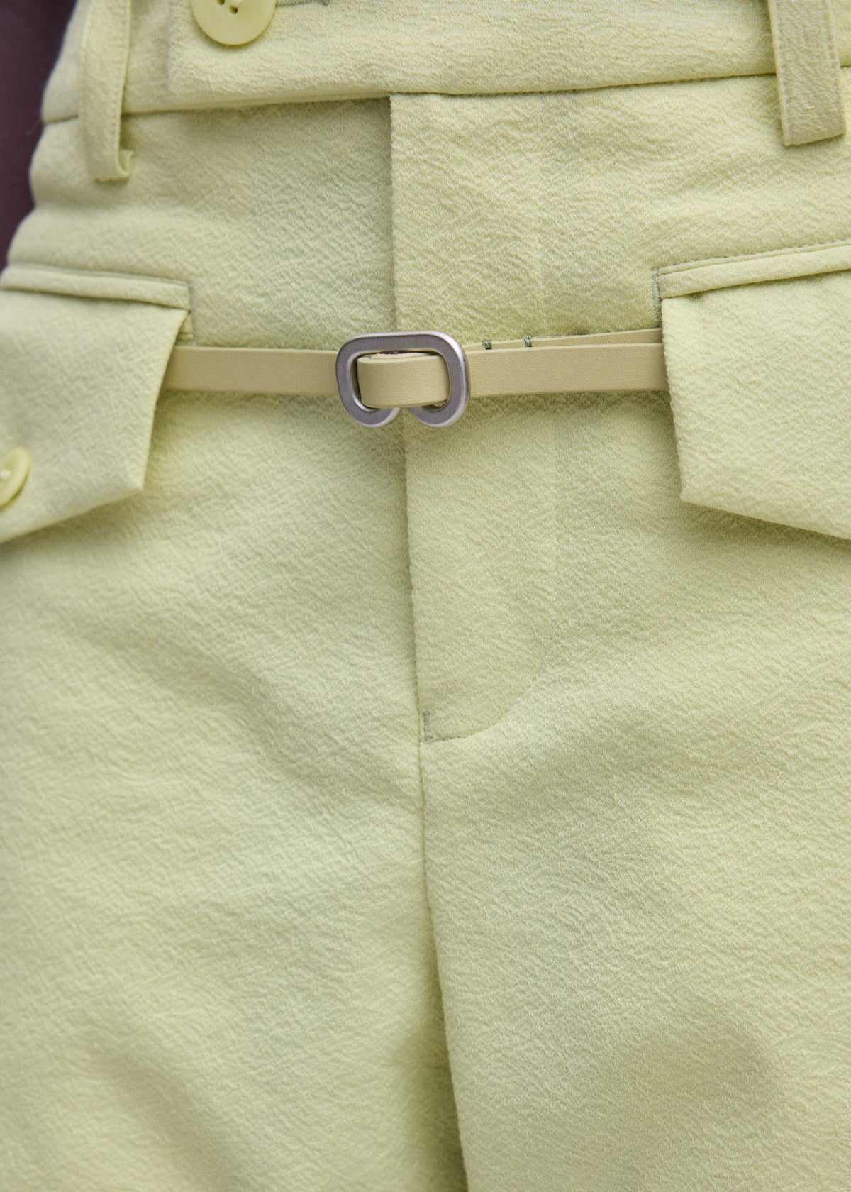 A model wears the ISSEY MIYAKE SOLID LEATHER BELT solid-leather-belt-belt-dark-brown-1.
