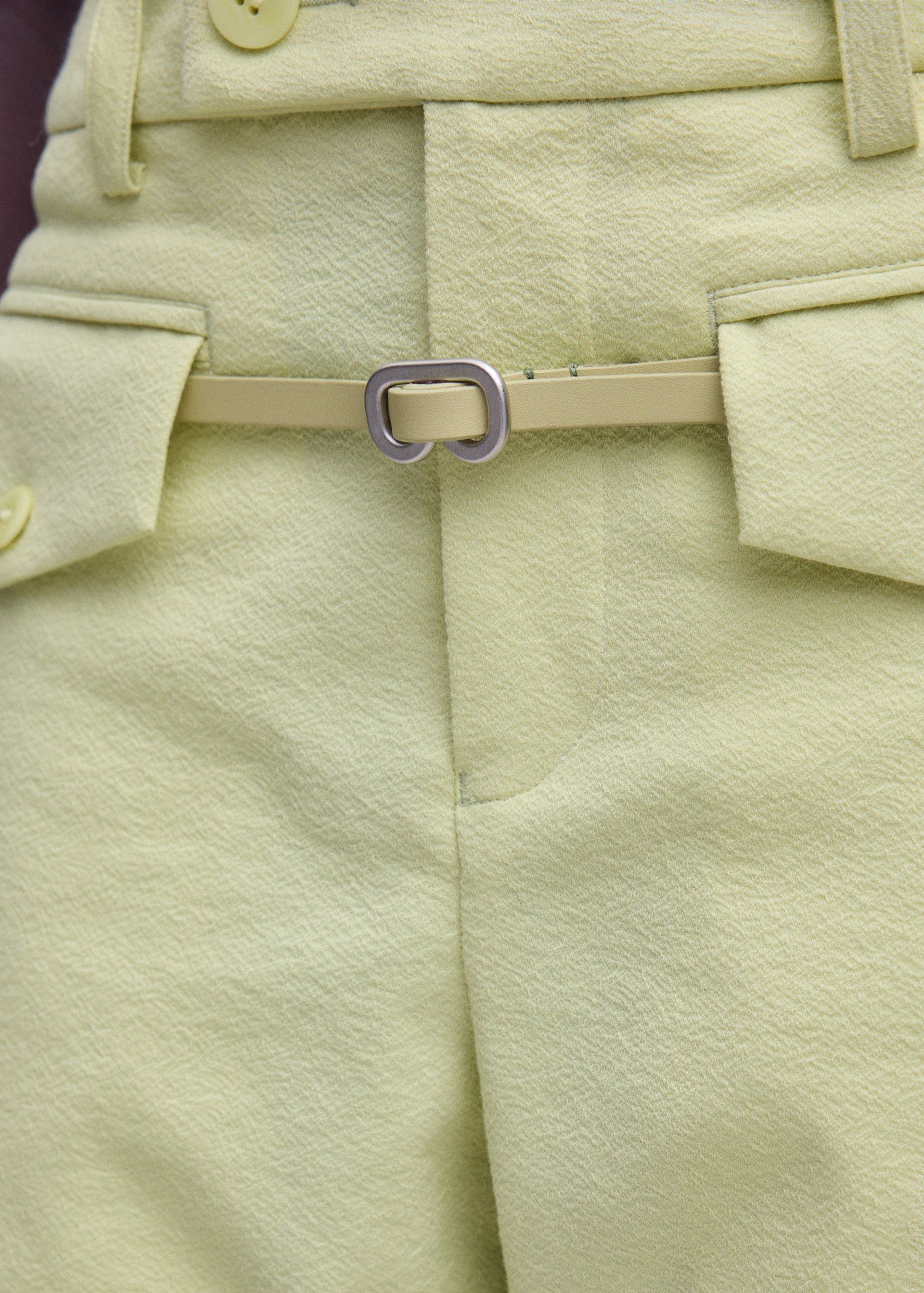 A model wears the ISSEY MIYAKE SOLID LEATHER BELT solid-leather-belt-belt-black-fw26.