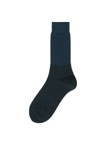 A product shot of the ISSEY MIYAKE SHEER RIB SOCKS socks in dark navy.