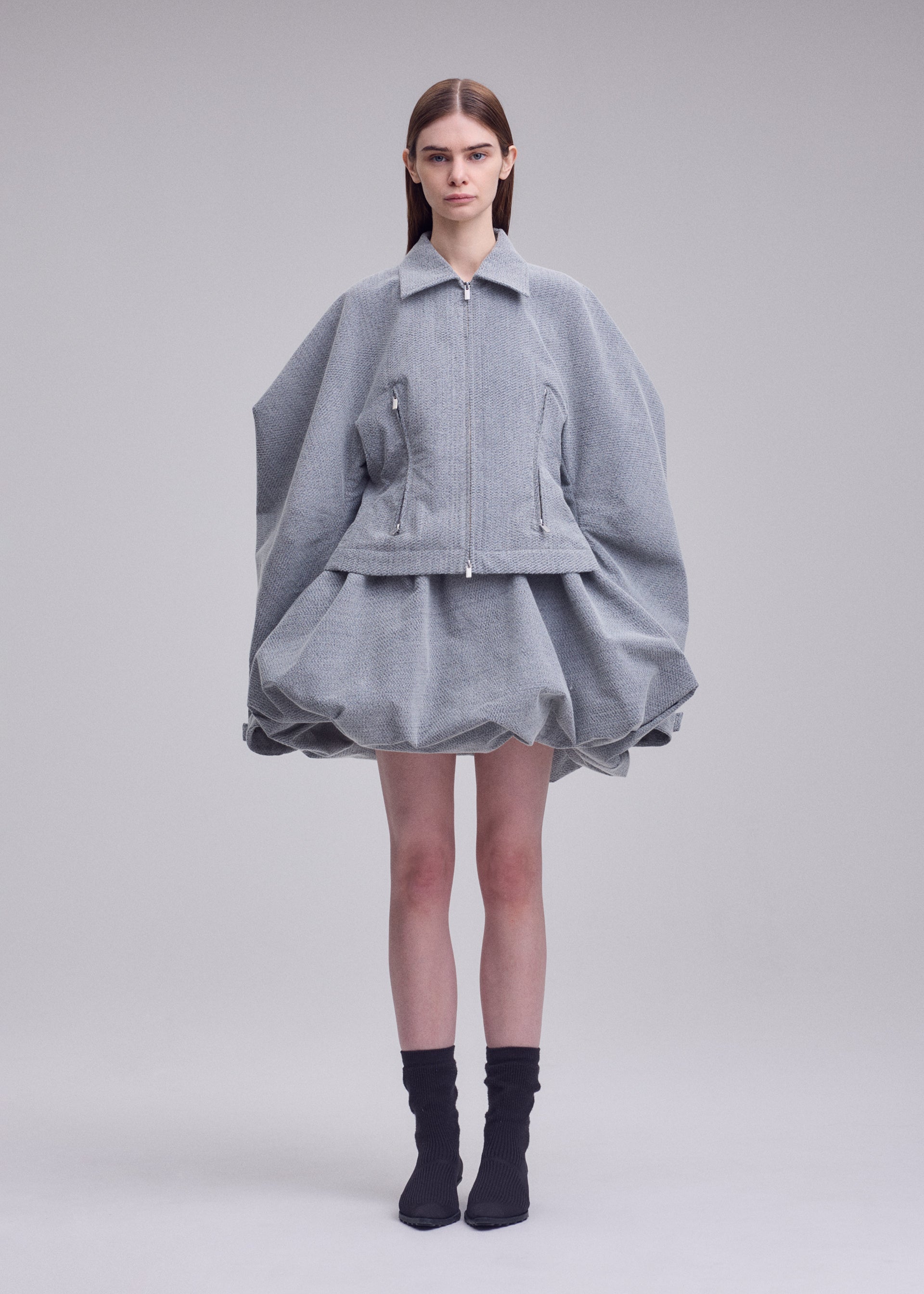 A model wears the ISSEY MIYAKE REFLECTION blouson.