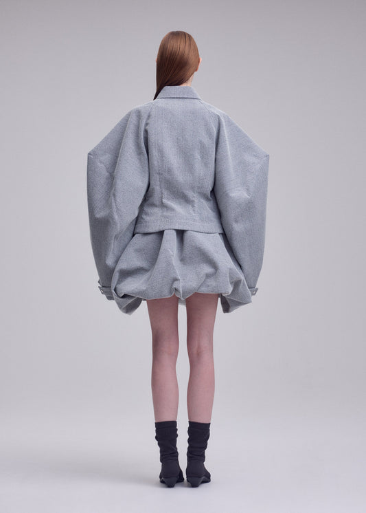 A model wears the ISSEY MIYAKE REFLECTION blouson.