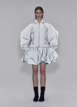 A model wears the ISSEY MIYAKE REFLECTION blouson.