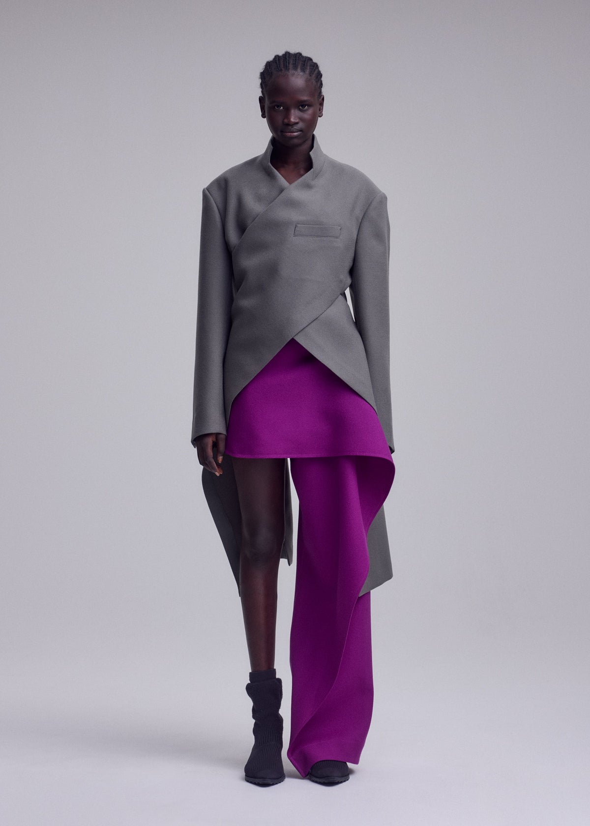 A model wears the ISSEY MIYAKE CALLIGRAPH jacket.